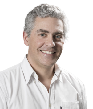 Dr. Miguel Assis professional portrait in white shirt